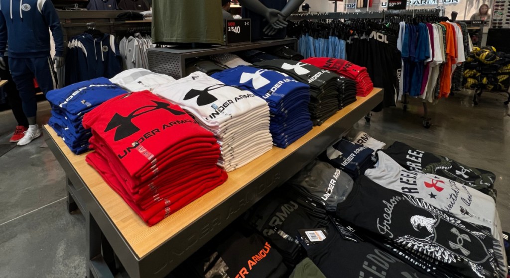 under armour tees on a store display table