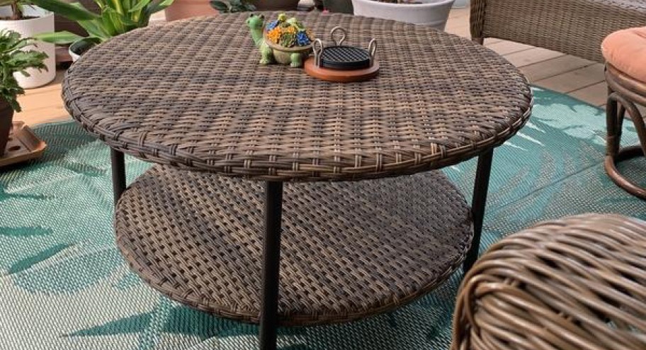 weaved outdoor table on top of a rug sitting outside