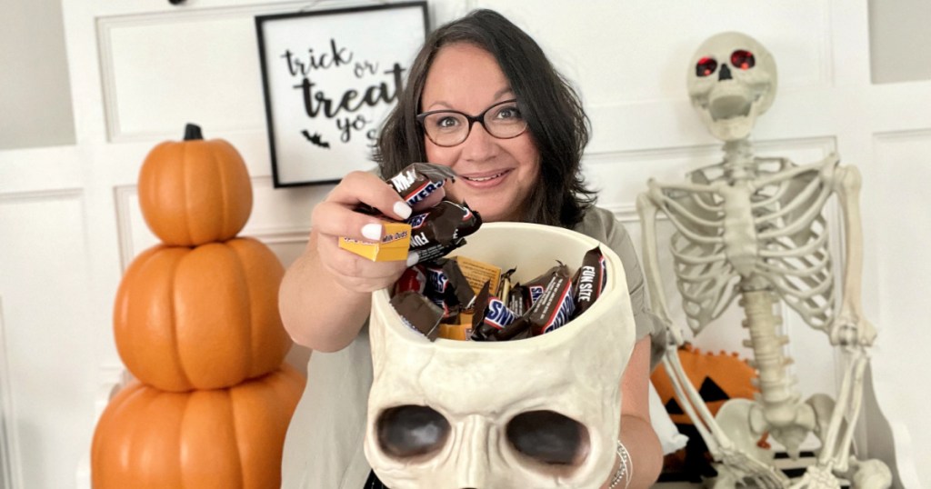 woman holding a skull candy bowl