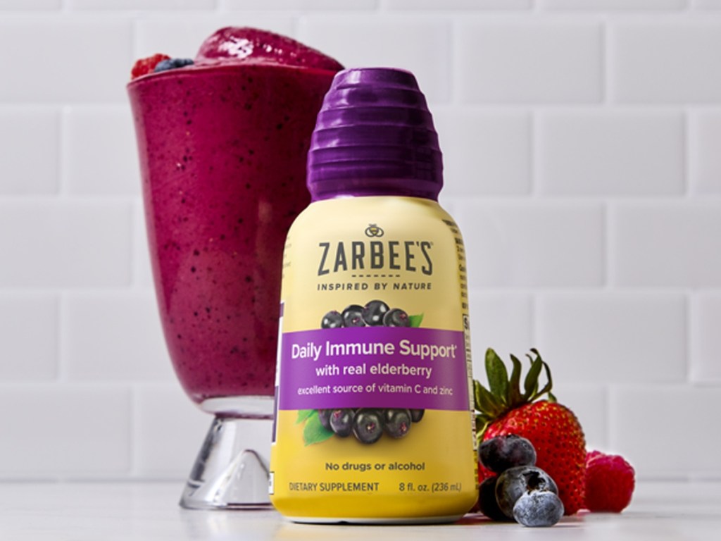 bottle of elderberry syrup next to smoothie