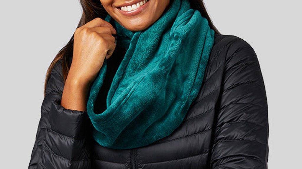 woman in black jacket with teal infinity scarf