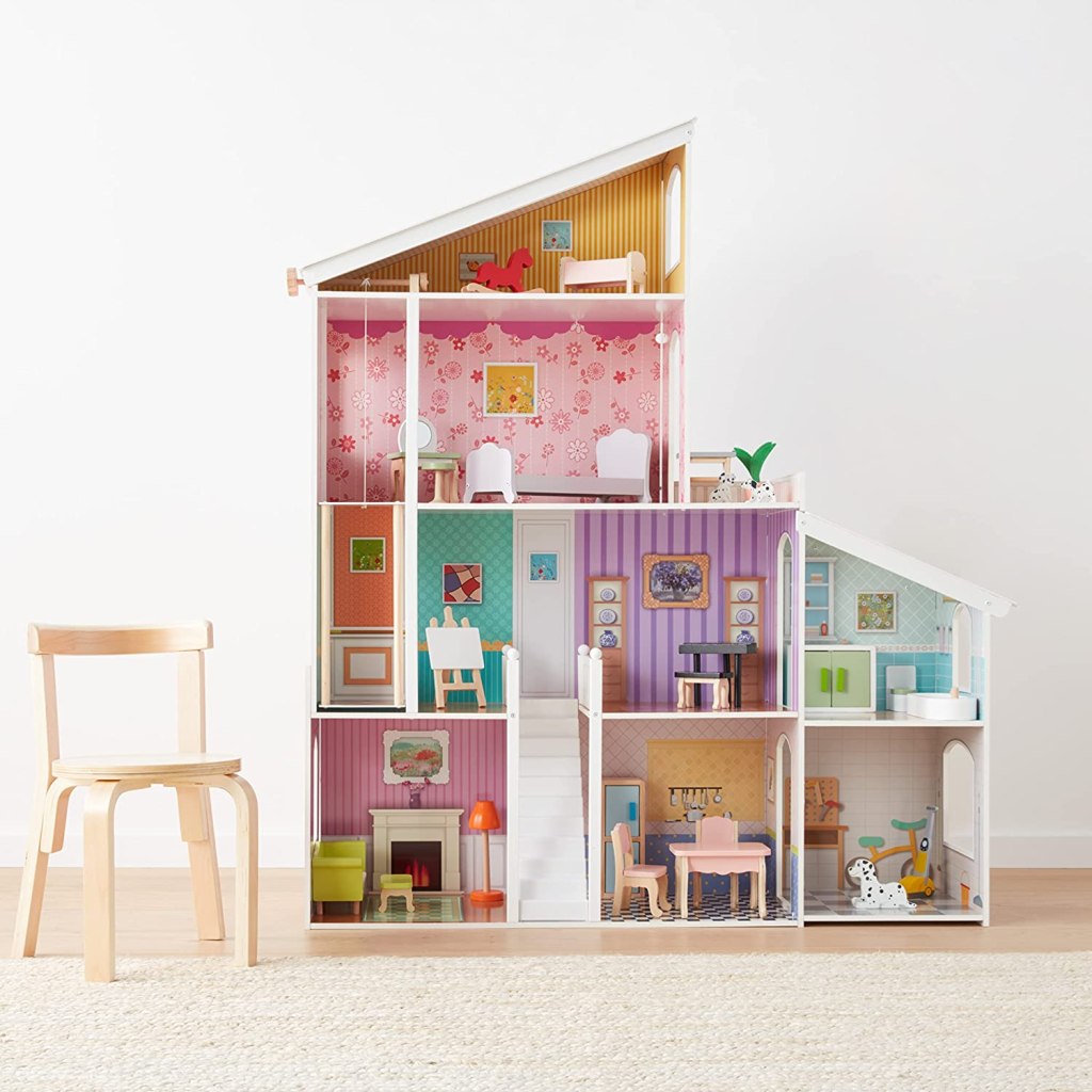 wooden dollhouse next to kids chair