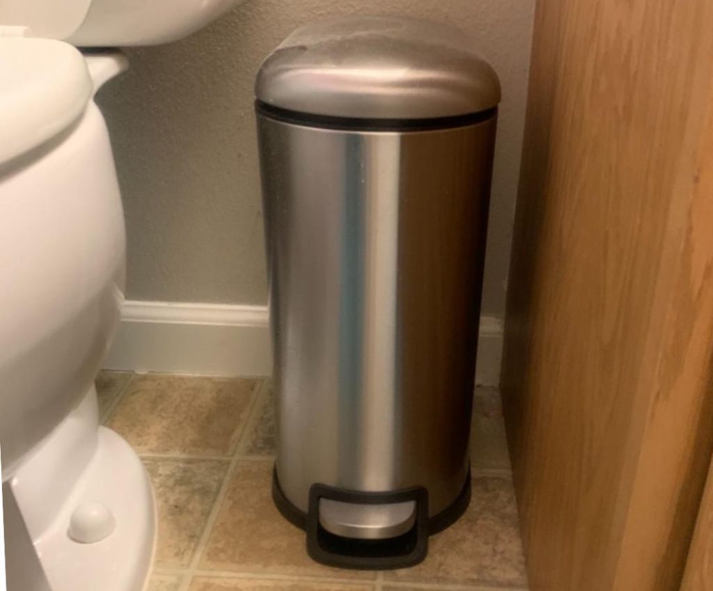 Small Amazon Basics Trash Can next to a toilet