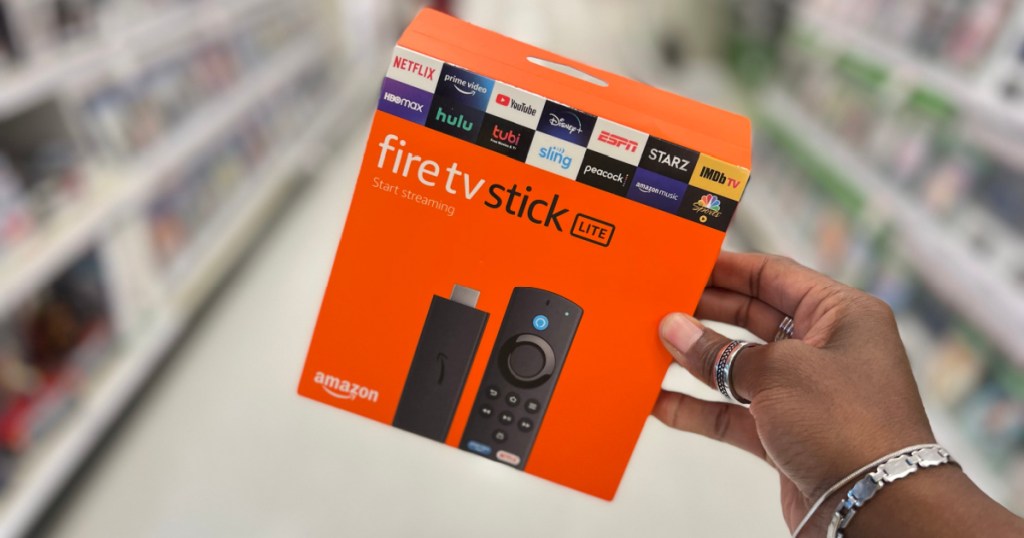 Person holding Amazon Fire TV Stick Lite in store aisle