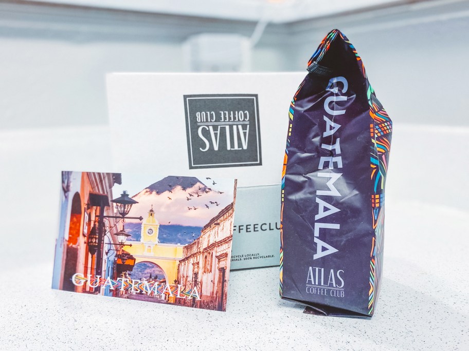 bag of Atlas Coffee and postcard near shipping box