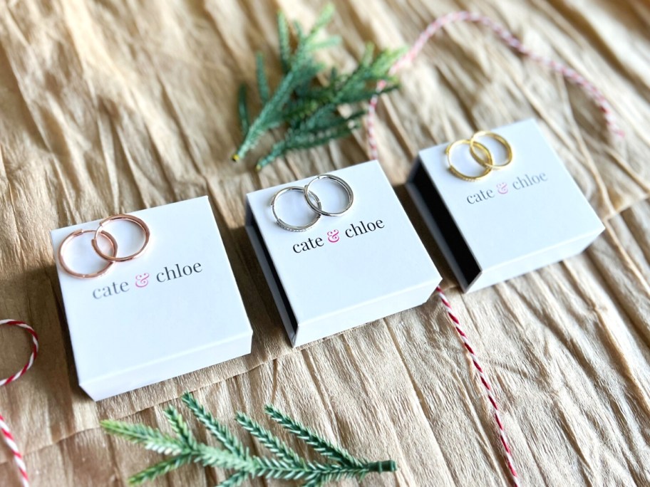 three pairs of Bianca 18K White Gold Plated Hoop Earrings w/ Swarovski Crystals on boxes