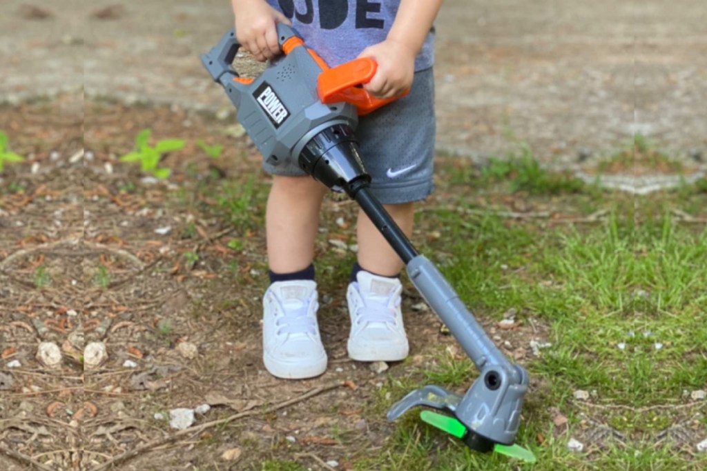 Boy holding play weed trimmer