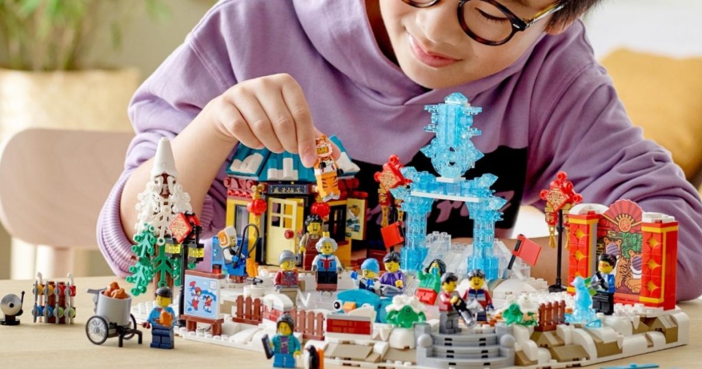 Boy playing with New Year Lego Set