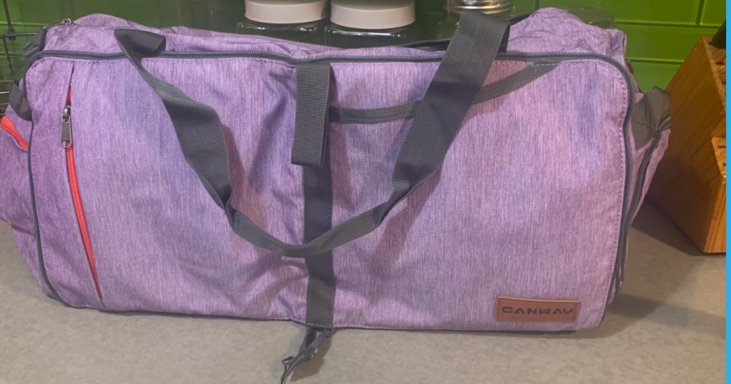 light purple duffel bag on counter top 