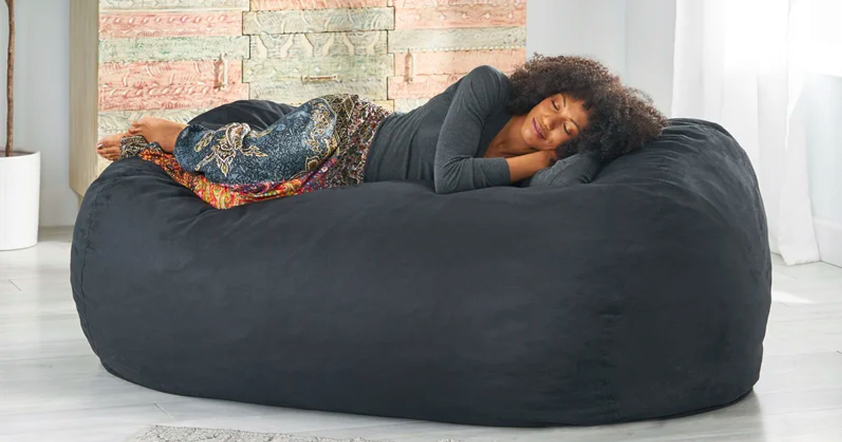 woman laying and sleeping on a bean bag lounger chair