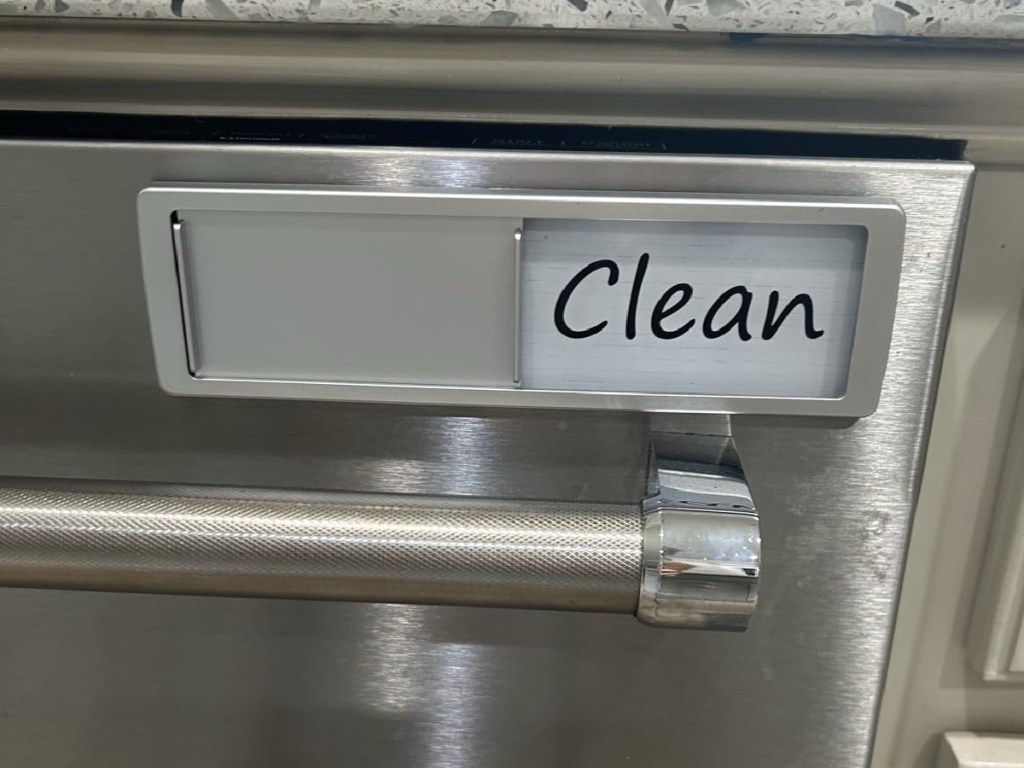 Clean Dishwasher sign on stainless steel dishwasher