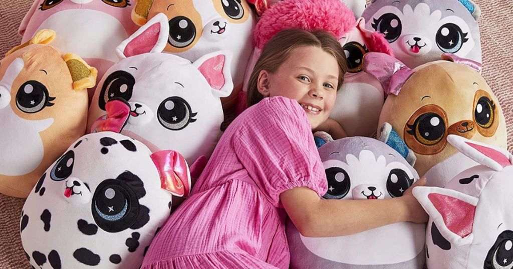 girl laying with a bunch of squishies around her