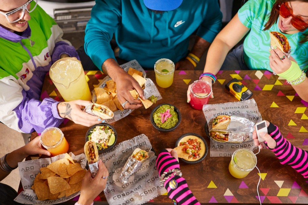 top-down view of a group of people eating tacos