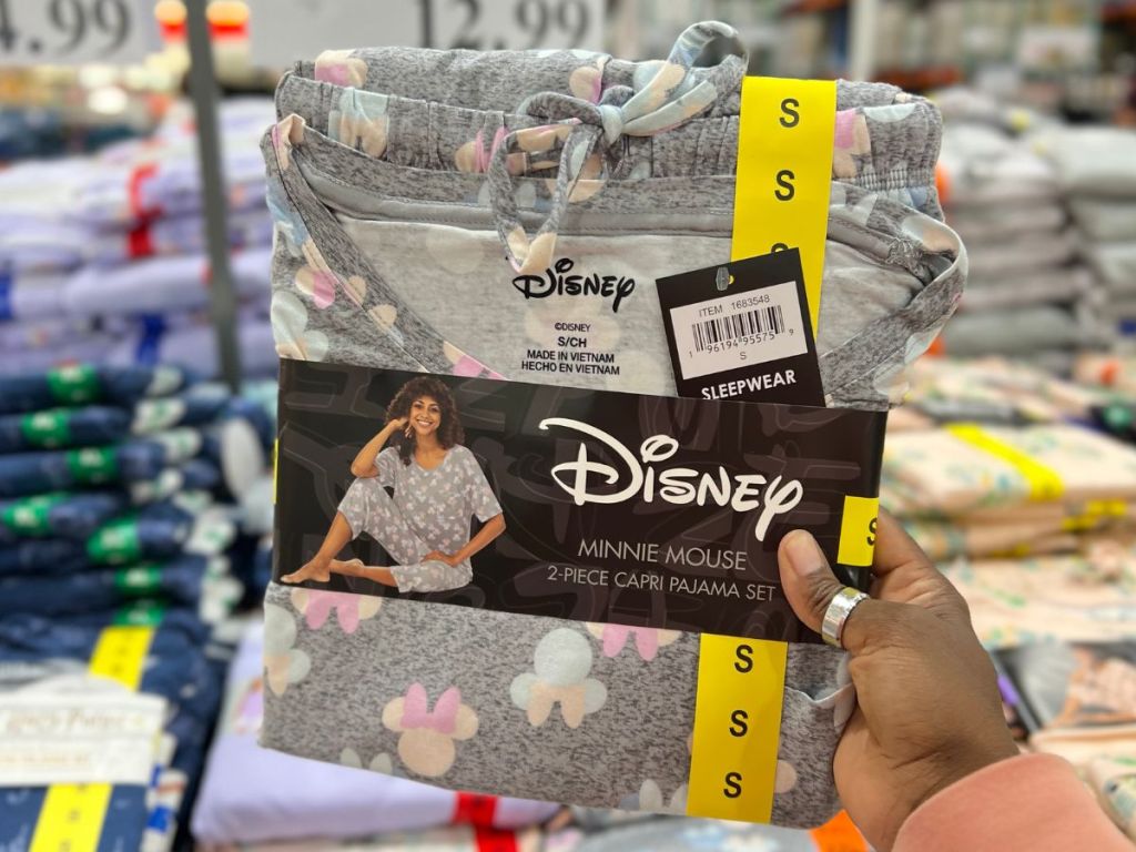 a hand in Costco holding Women's Disney Minnie Mouse Pajamas