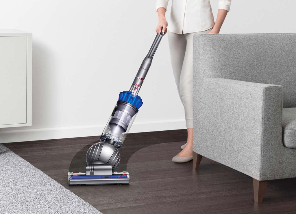 woman using dyson vacuum