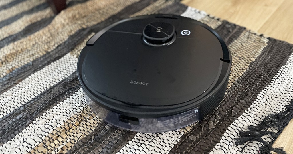 black robotic vacuum cleaner on rug