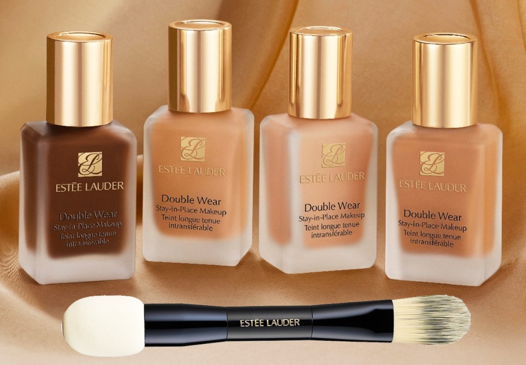 four bottles of Estee Lauder Double Wear Foundation with a foundation brush