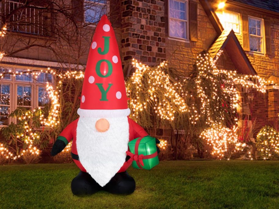 Glitzhome 6' Lighted Gnome Christmas Inflatable in front of house