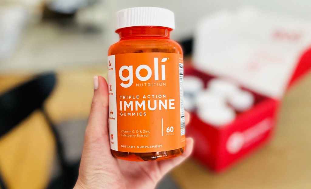 holding bottle of Goli Nutrition Triple Action Immune Gummies