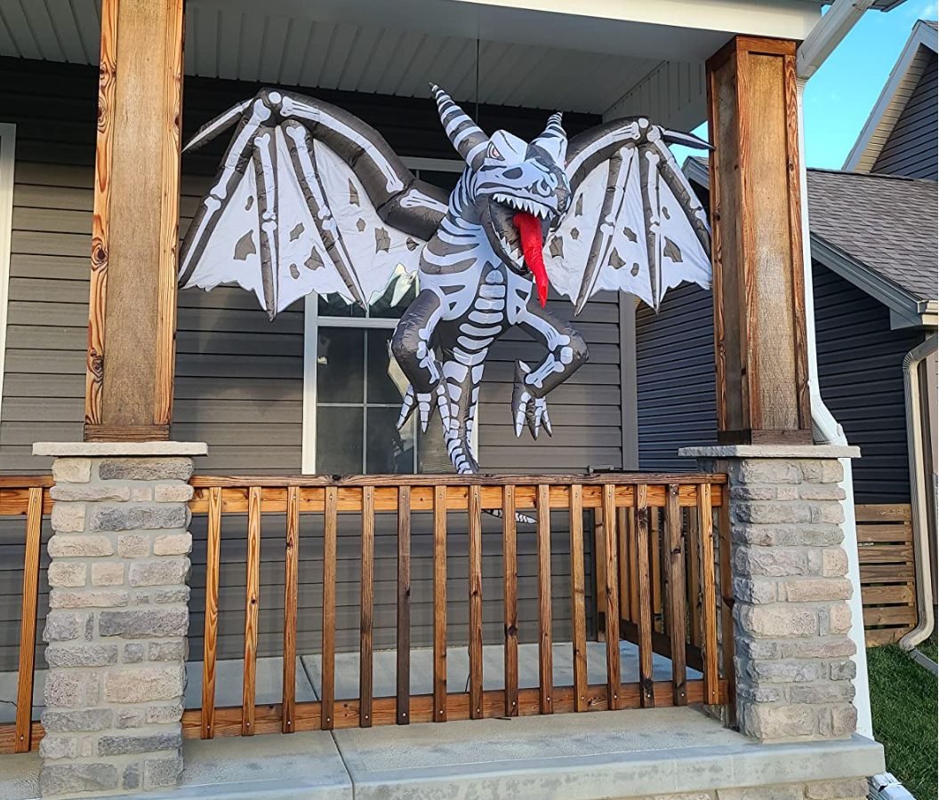 Goosh Halloween Inflatables Dinosaur Hanging from a porch