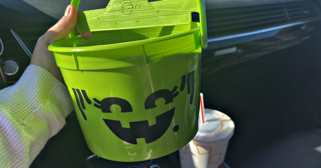 Person holding Green McDonalds Happy Meal Bucket
