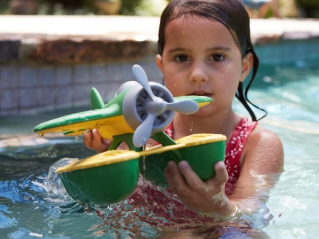 little girl playing with Green Toys Sea Plane in pool