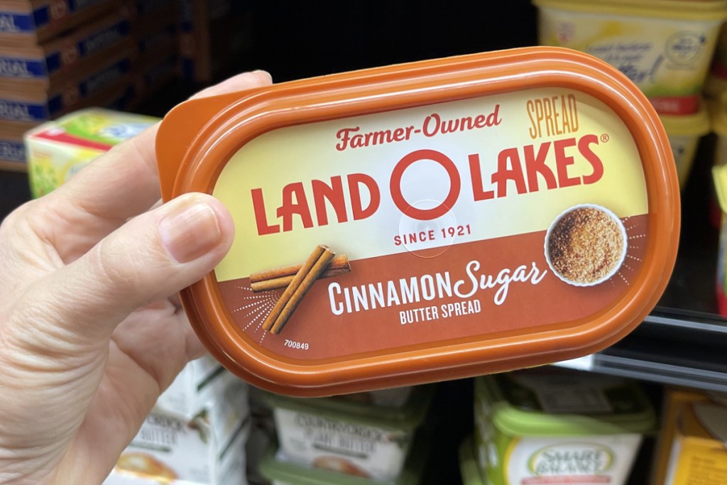 Hand holding Land O Lakes Cinnamon Sugar