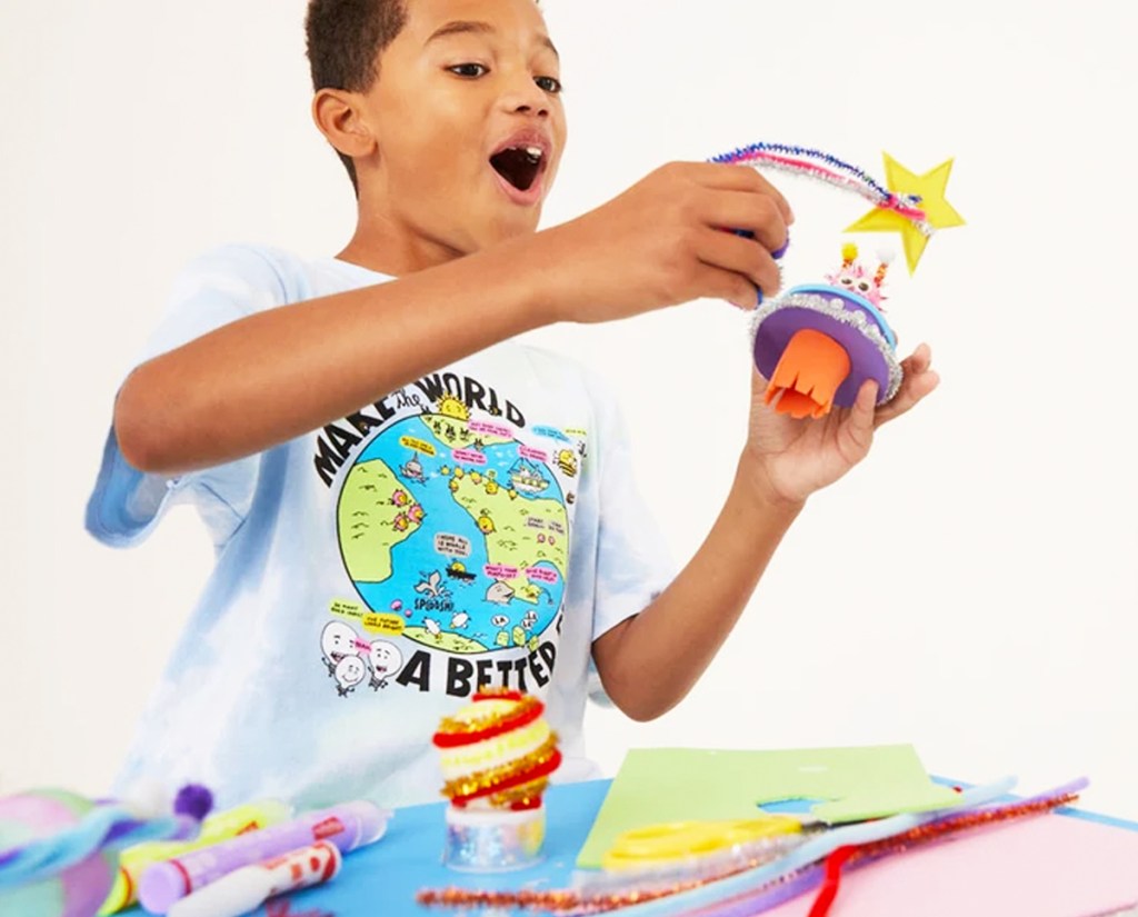 boy holding solar system craft