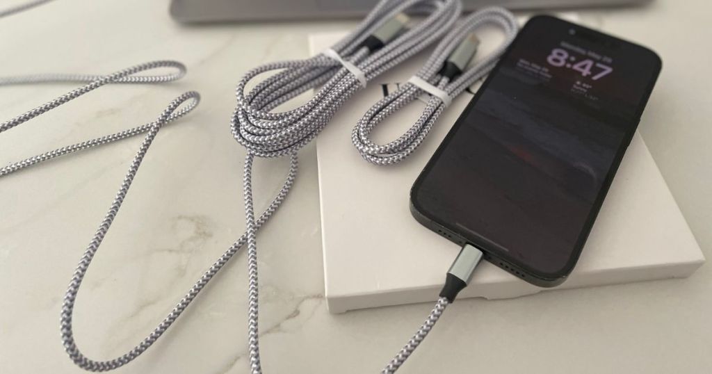 iPhone connected to a grey charging cable