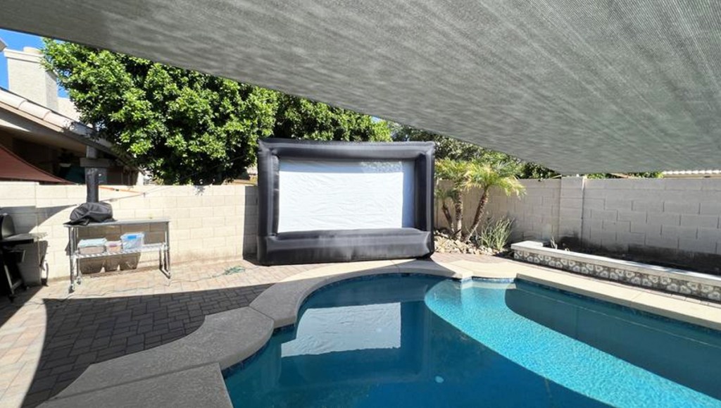 Inflatable Outdoor Screen in backyard next to pool