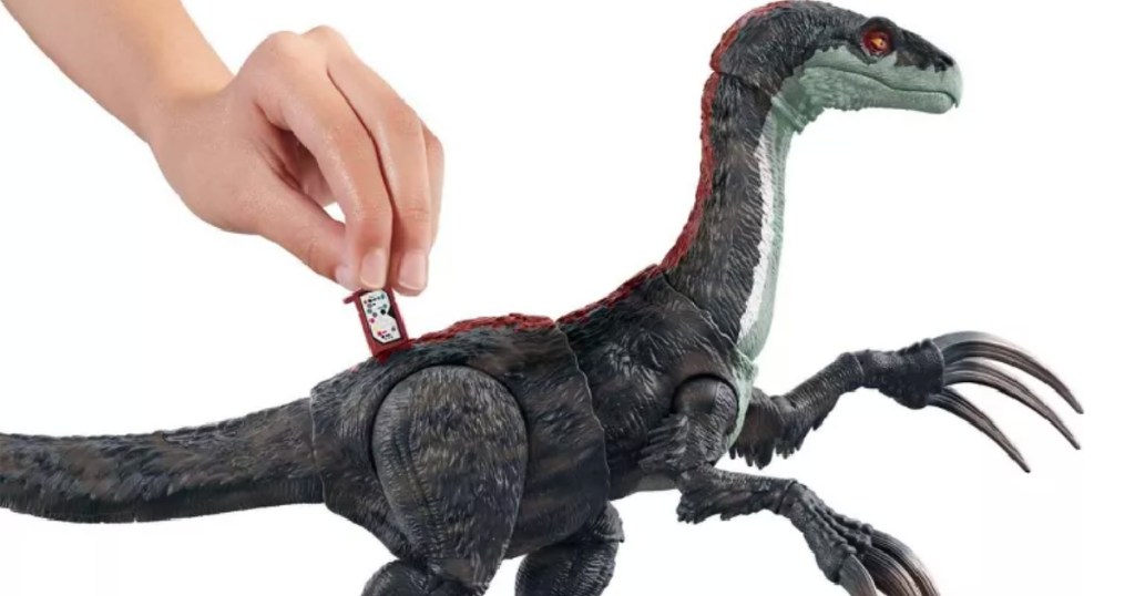 hand putting card in dinosaur 