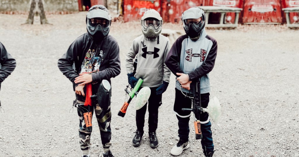 3 boys outside holding paintballing guns