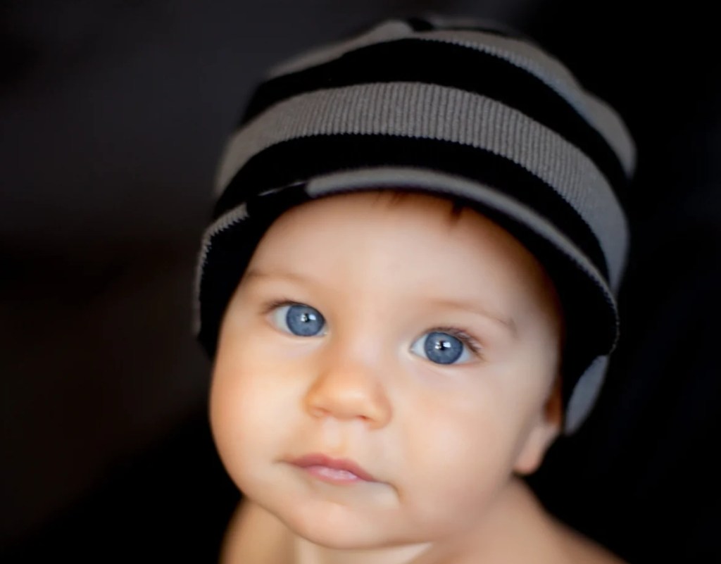 baby wearing a Knuckleheads Striped Beanie