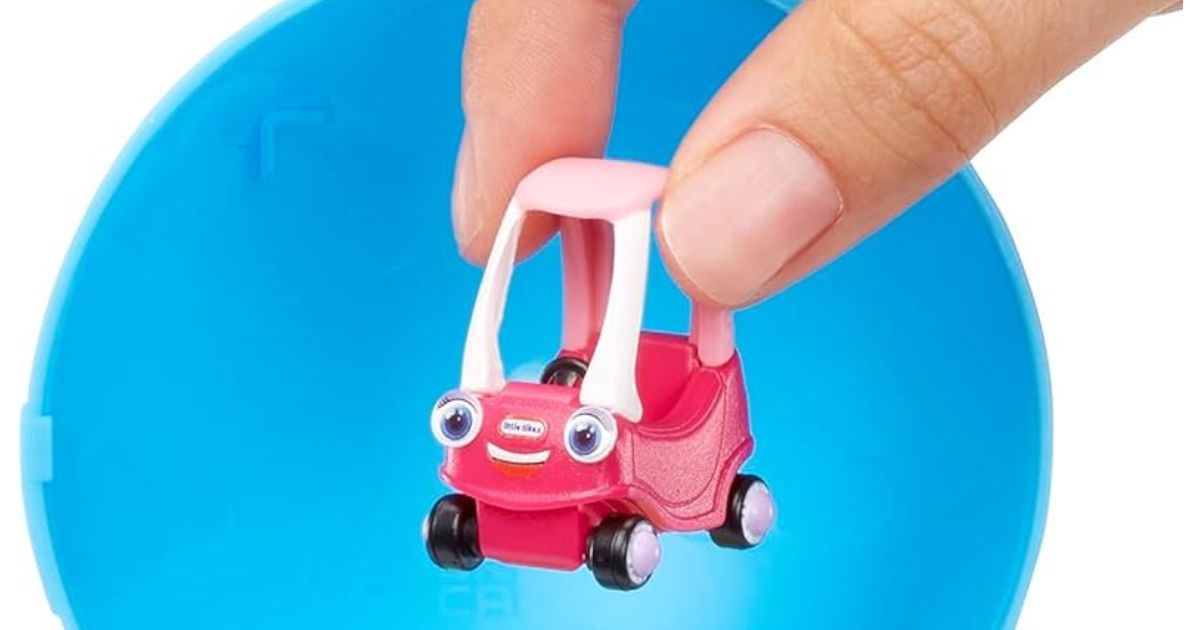 Finger tips holding a Little Tikes Mini Cozy Coupe