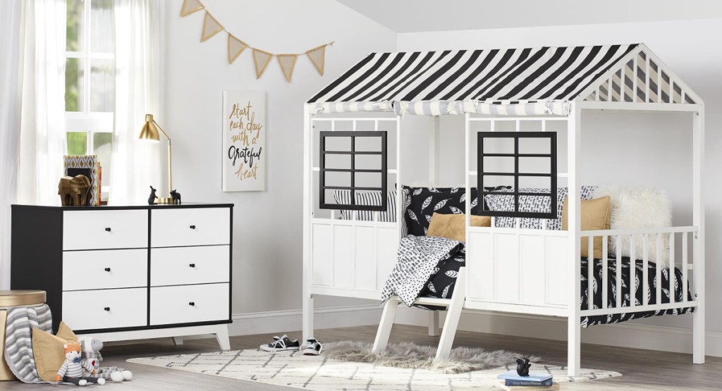 Loft bed displayed in toddler bedroom with black and white decor