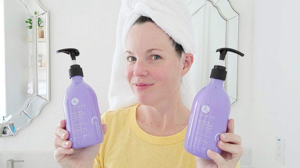 woman holding Luseta shampoo and conditioner