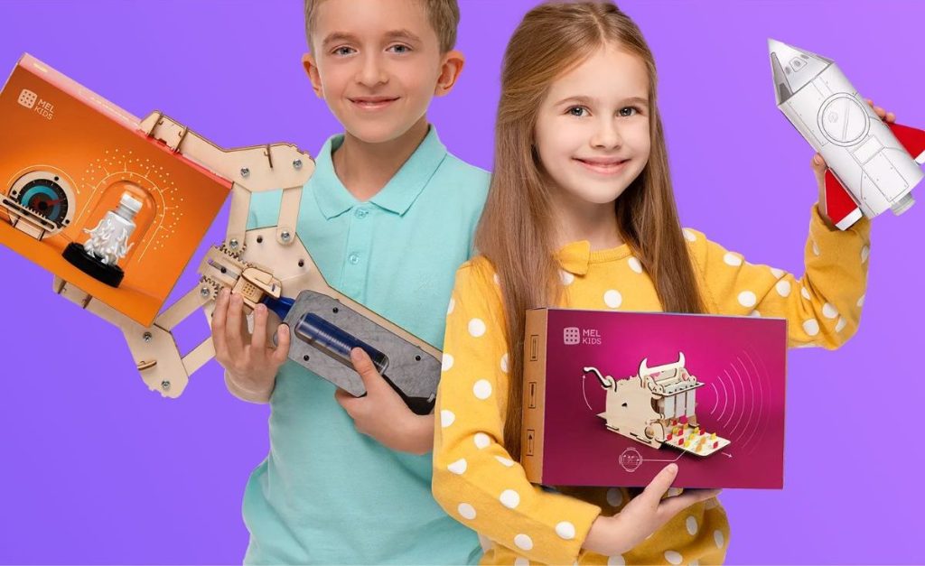 a boy and a girl holding Mel Science Space Kits