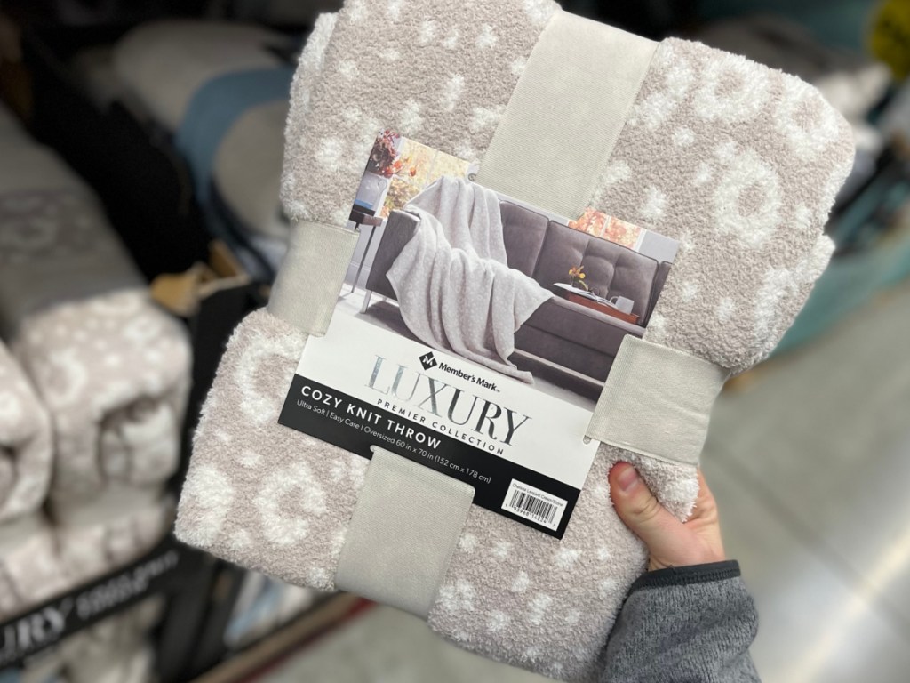 person holding up Members Mark Luxury Cozy Knit Throw Collection