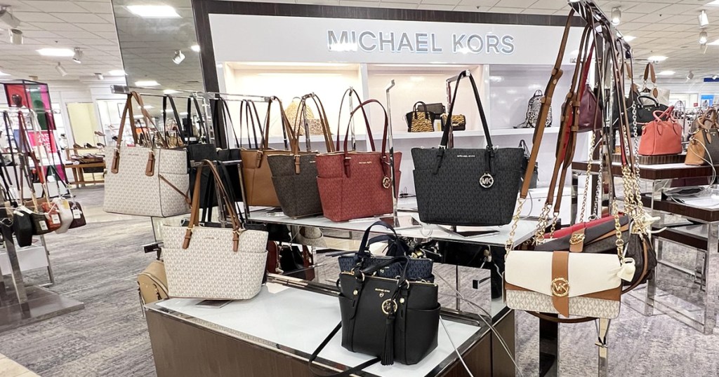 display of michael kors bags in store