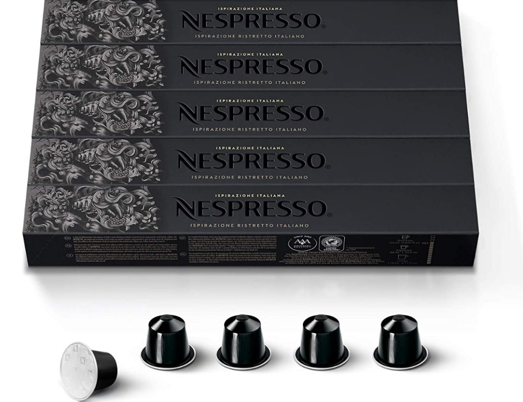 Boxes of Nespresso capsules and a row of capsules beneath the boxes