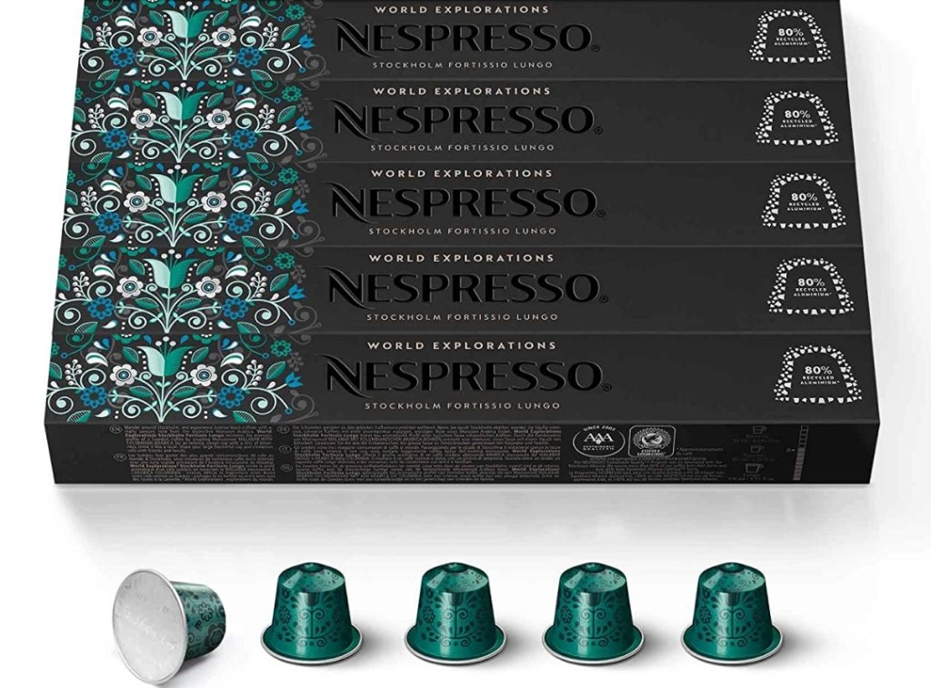 Boxes of Nespresso capsules and a row of capsules beneath the boxes