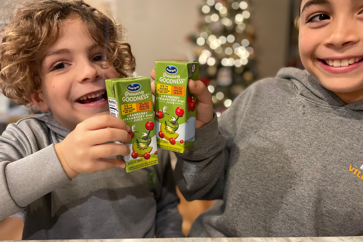 two boys holding Ocean Spray Growing Goodness Juice Boxes