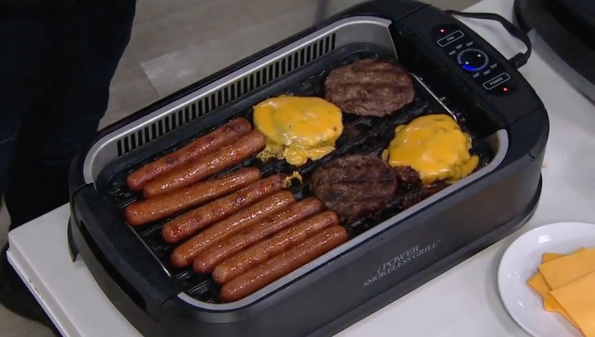 A PowerXL Smokeless Griddle filled with burgers and hot dogs