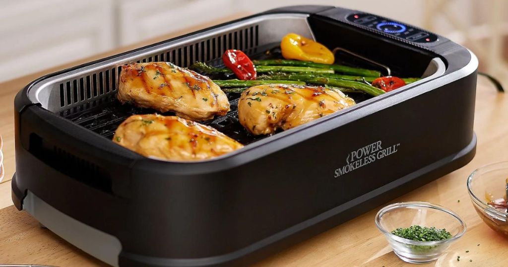 PowerXL Smokeless Griddle with Chicken in it
