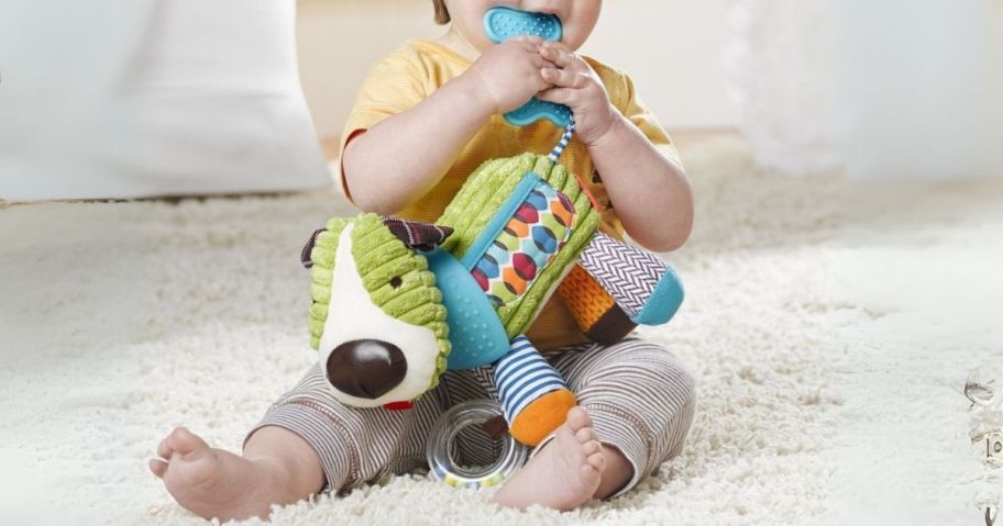 baby playing with Skip Hop Bandana Buddies Puppy