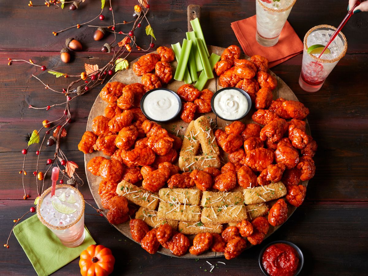 plate of wings and mozzeralla sticks in the shape of a face