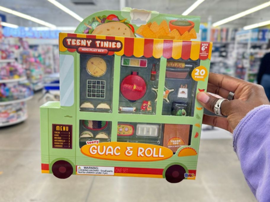 hand holding a Teeny Tinies foodies mini play set in the shape of a Taco Food Truck 