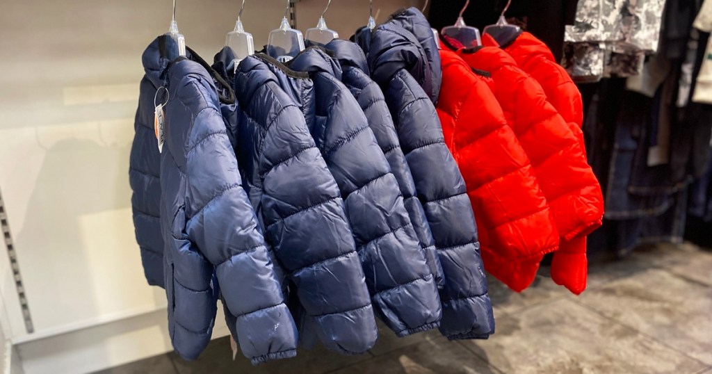 navy blue and red puffer jackets on hangers