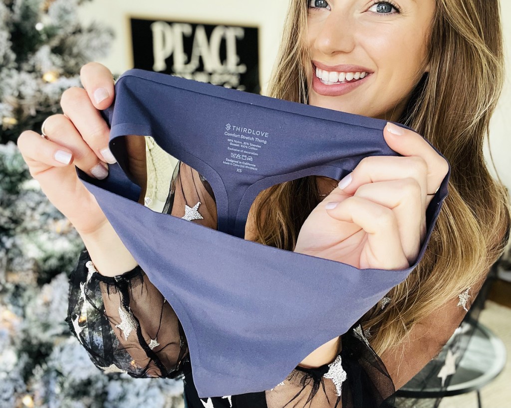 woman holding up pair of underwear