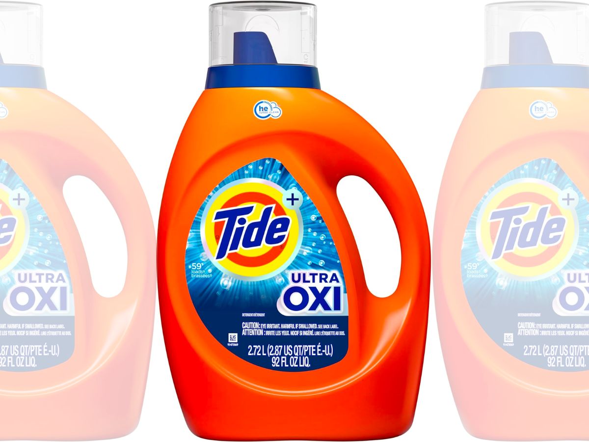 Tide Ultra plus Oxi Liquid Laundry Detergent in an orange bottle on a white background stock image